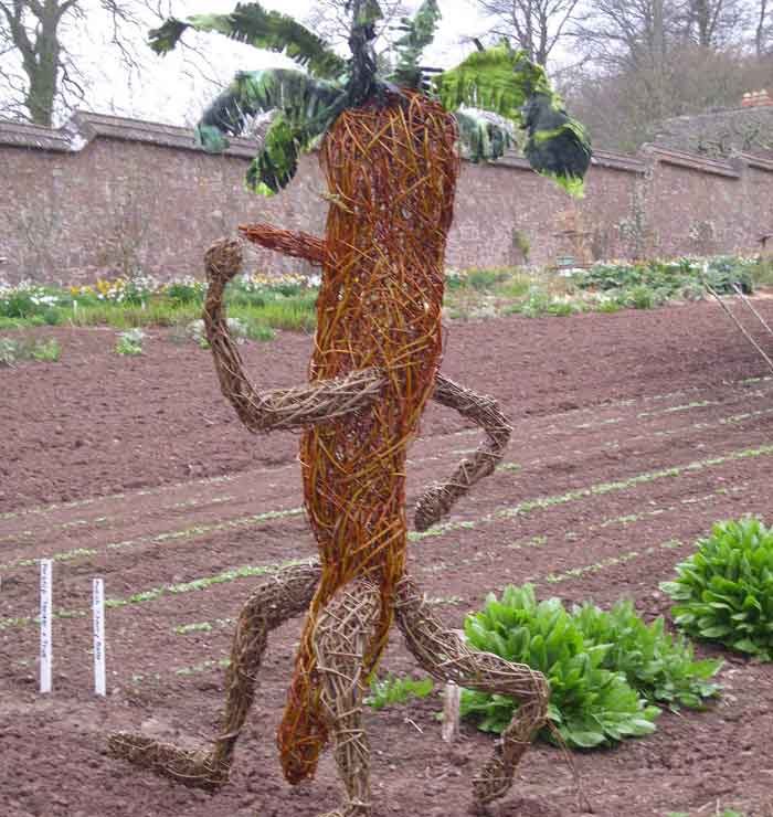 Willow sculpture of giant walking carrot man