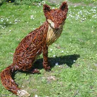 Willow sculpture of a sitting fox