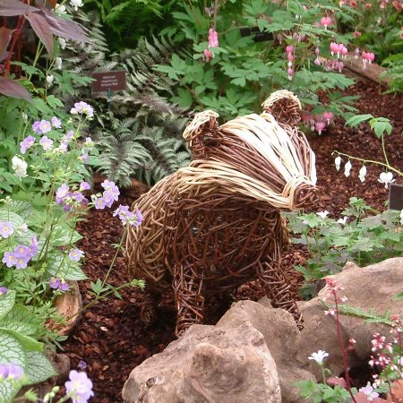 Willow sculpture of a badger at chelsea flower show