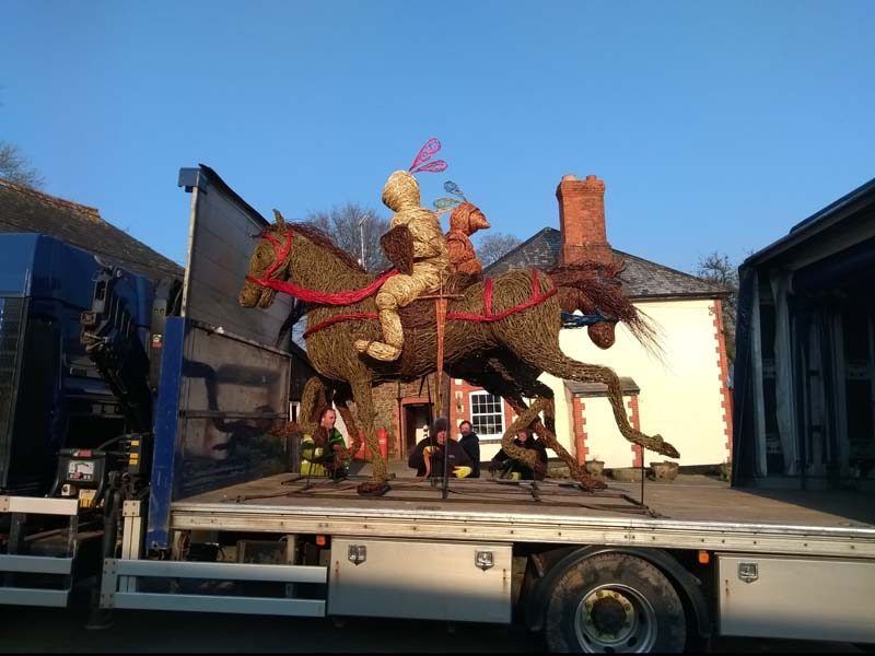 Both jousting knights on horseback willow sculptures on the lorry.